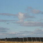 A general view of a wind turbine and solar panels at Westmill Wind Farm & Solar Park - source