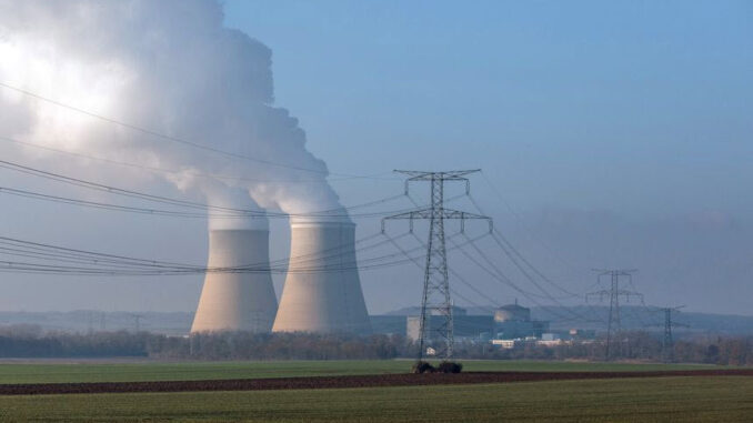 Cooling towers release water vapor beyond high tension electricity lines at the Nogent nuclear power plant in Nogent-sur-Seine, France, Dec. 21, 2021. -ENB