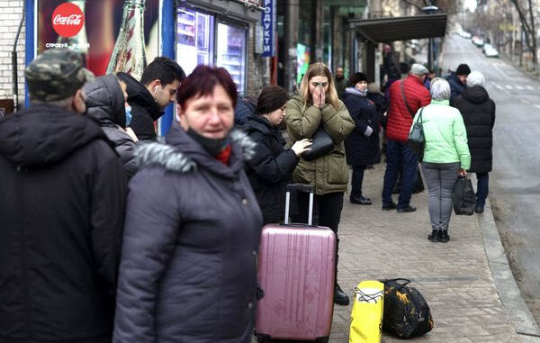 Ukraine - Residents with belongings wait for public transport