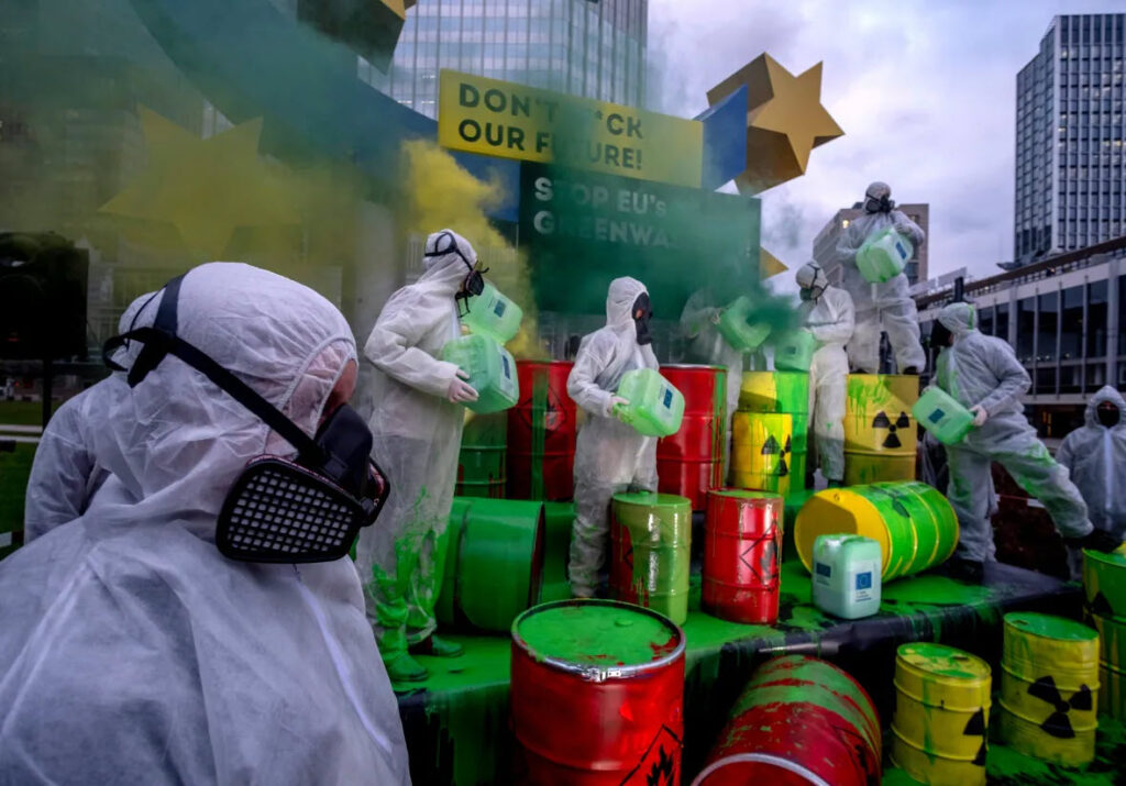 Environmental activists with Greenpeace and the "Koala Kollektiv" protest against the European Union's greenwashing of nuclear energy under the Euro sculpture in Frankfurt, Germany 