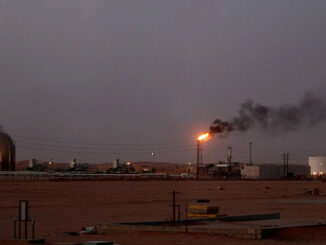 A flame from a Saudi Aramco oil installation known as “Pump 3” burns brightly during sunset in the desert near the oil-rich area Al-Khurais.