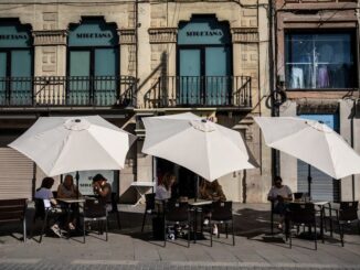 Customers shelter from the sun at a cafe in Lleida, Spain.Photographer: Angel Garcia/Bloomberg